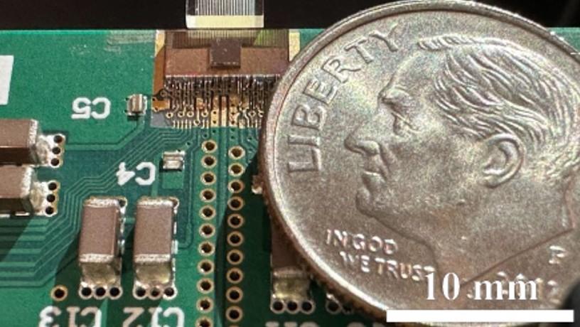 An ultra-compact photonic data transmission system with a dime for scale