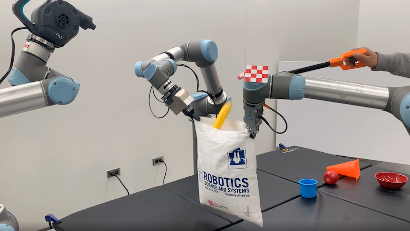 A three-arm robot using airflow to open a bag.