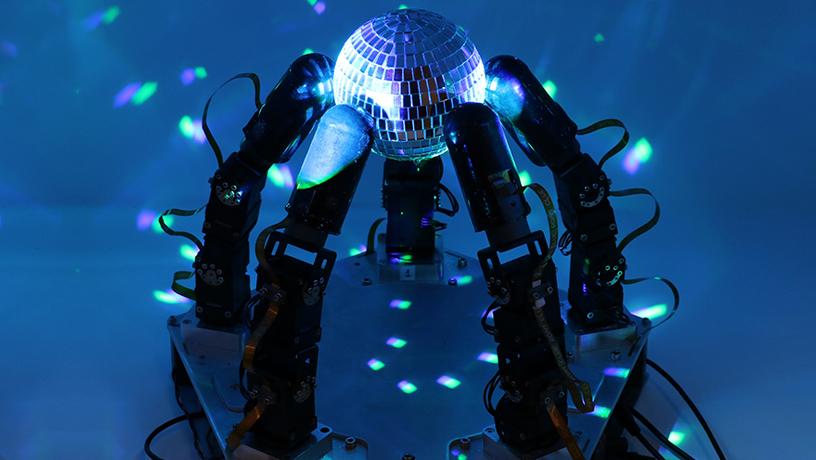 Robot hand holding a disco ball in the dark