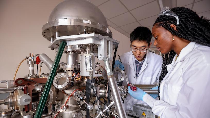 Students loading samples into an x-ray photoelectron spectrometer