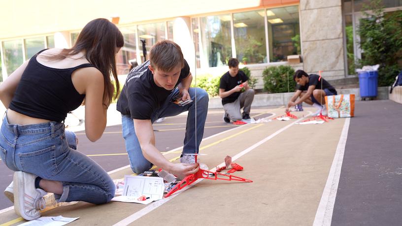 Students setting up a rocket for launch