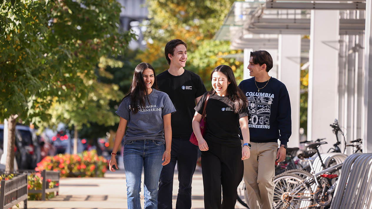A group of four Columbia Engineering students walk down an NYC sidewalk.