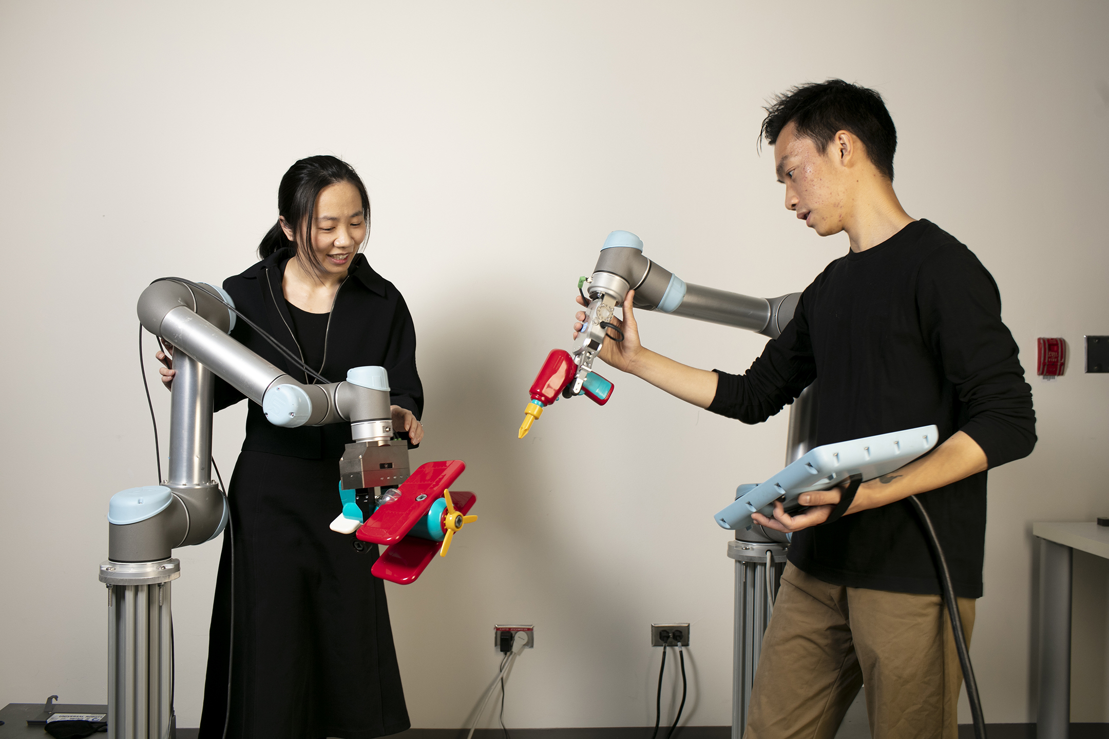 Students manipulate robotic arms