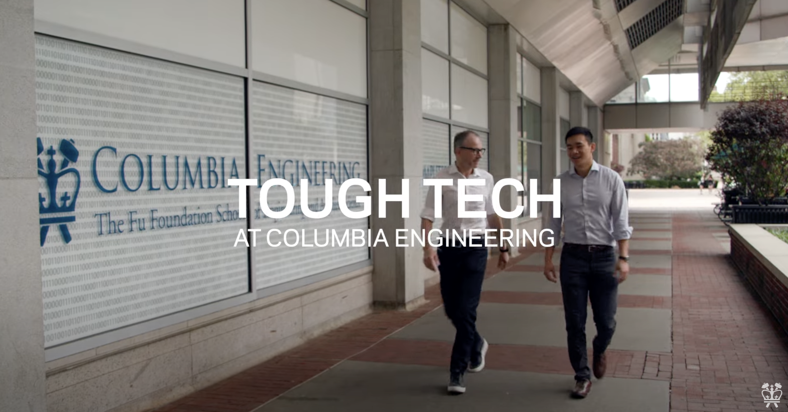 Two men walking in front of a Columbia Engineering logo. 