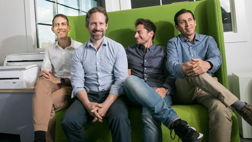 The Kelvin team sitting on a green couch.