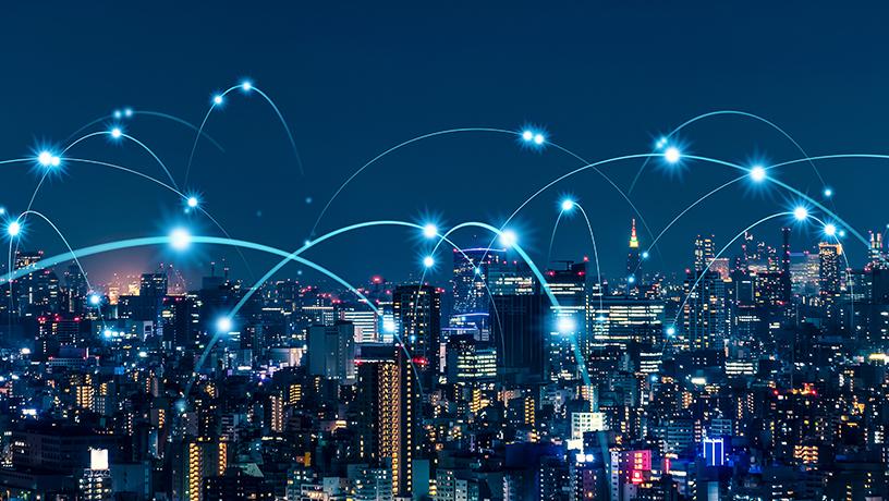 An abstract image of a city skyline with bright data connections