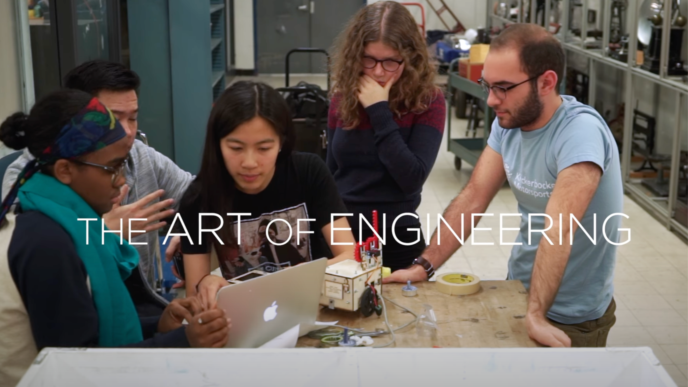 Columbia Engineering gather around a laptop in the lab.