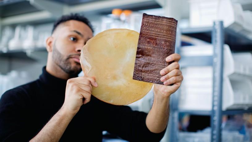 Romare Antrobus, PhD student and co-lead author of the study, examining a sample of compostable bioleather 