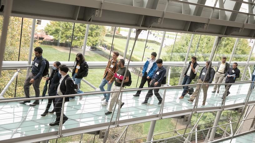 2022 CAIT symposium attendees walking along an elevated platform