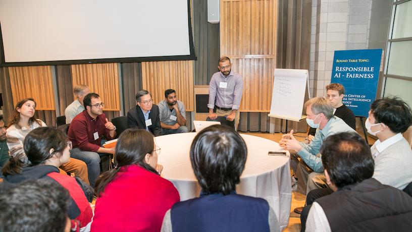 2022 CAIT symposium attendees surround a round table for discussion