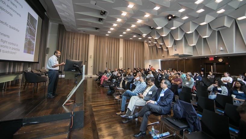 An AI expert presents to a crowd at the second annual CAIT symposium.
