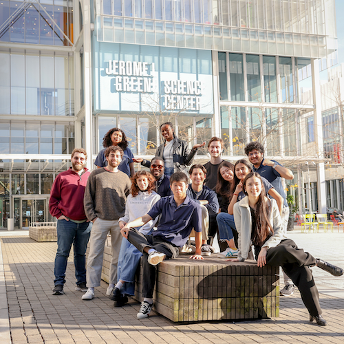 14 Columbia students posing for a photo outside the Jerome L. Greene Science Center