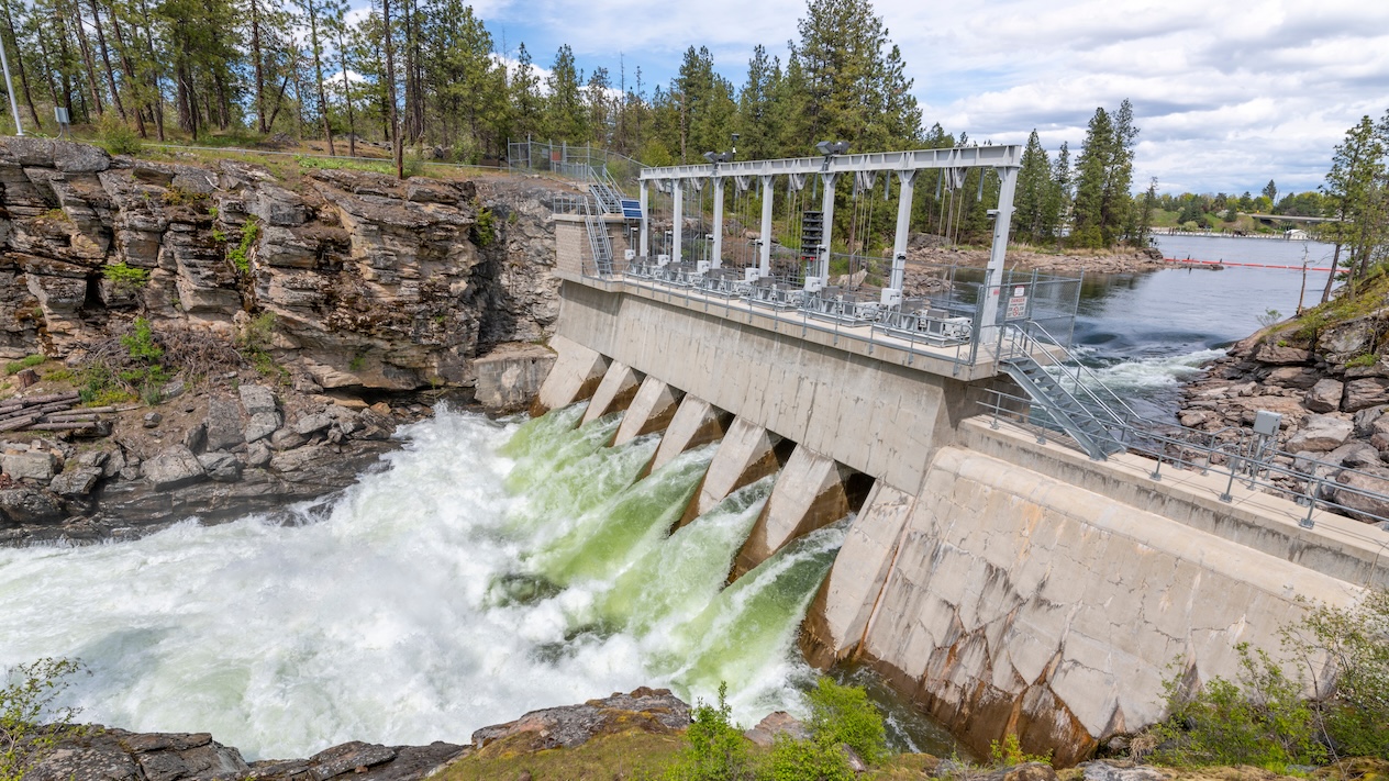 The Avista Dam at Falls Park along the Spokane River with roaring rapids in the rural town of Post Falls, Idaho.