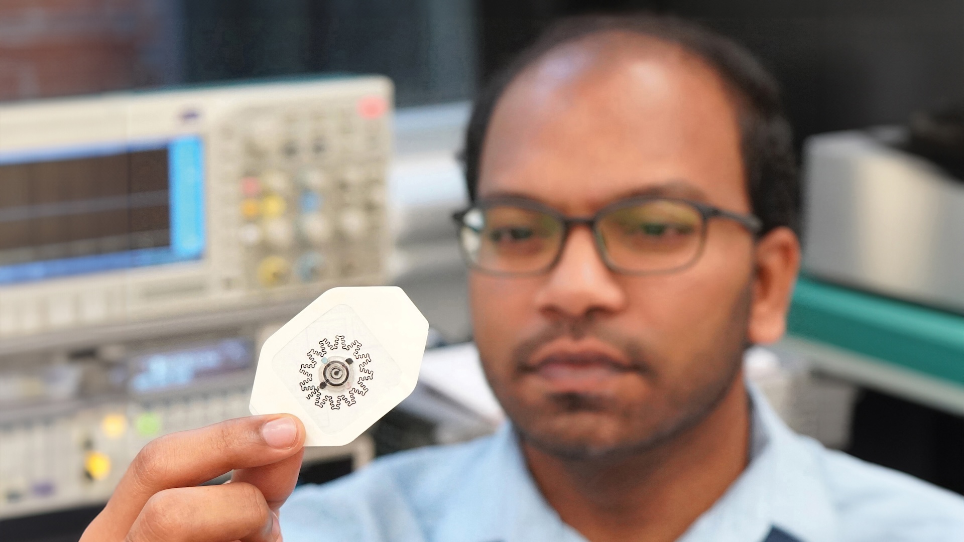 Rajaram Kaveti holding the water-powered, electronics-free dressing for electrical simulation
