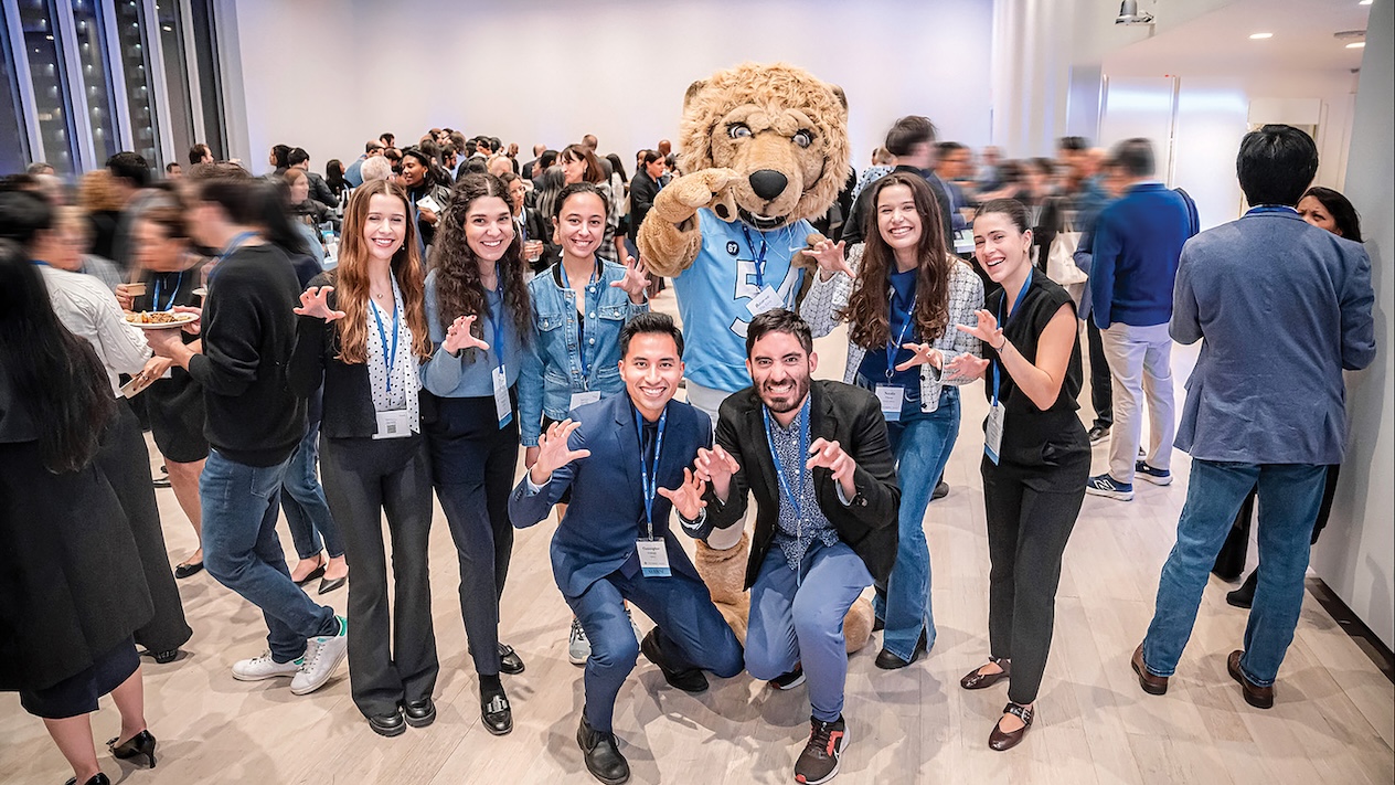 Seven Columbia Engineering alums posing with Roar-ee