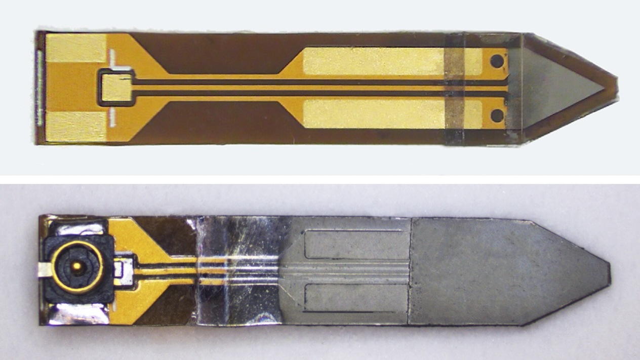 The top image shows the sensor before depositing the ground layer, with the triangular electrode in view, and the bottom image shows a finished sensor. 