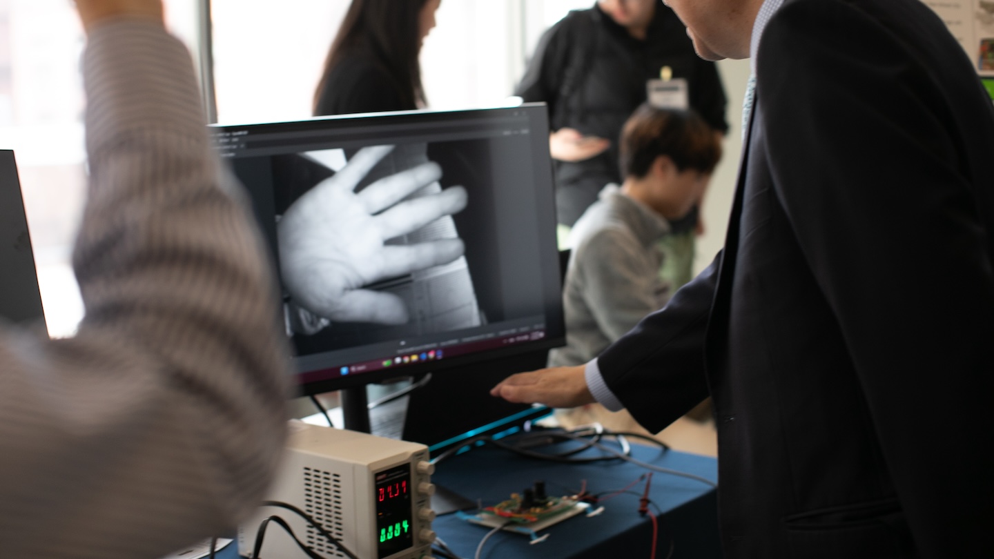 Xia Zhou’s lab showcases hardware prototype for palm vein pattern recognition using near-infrared imaging.