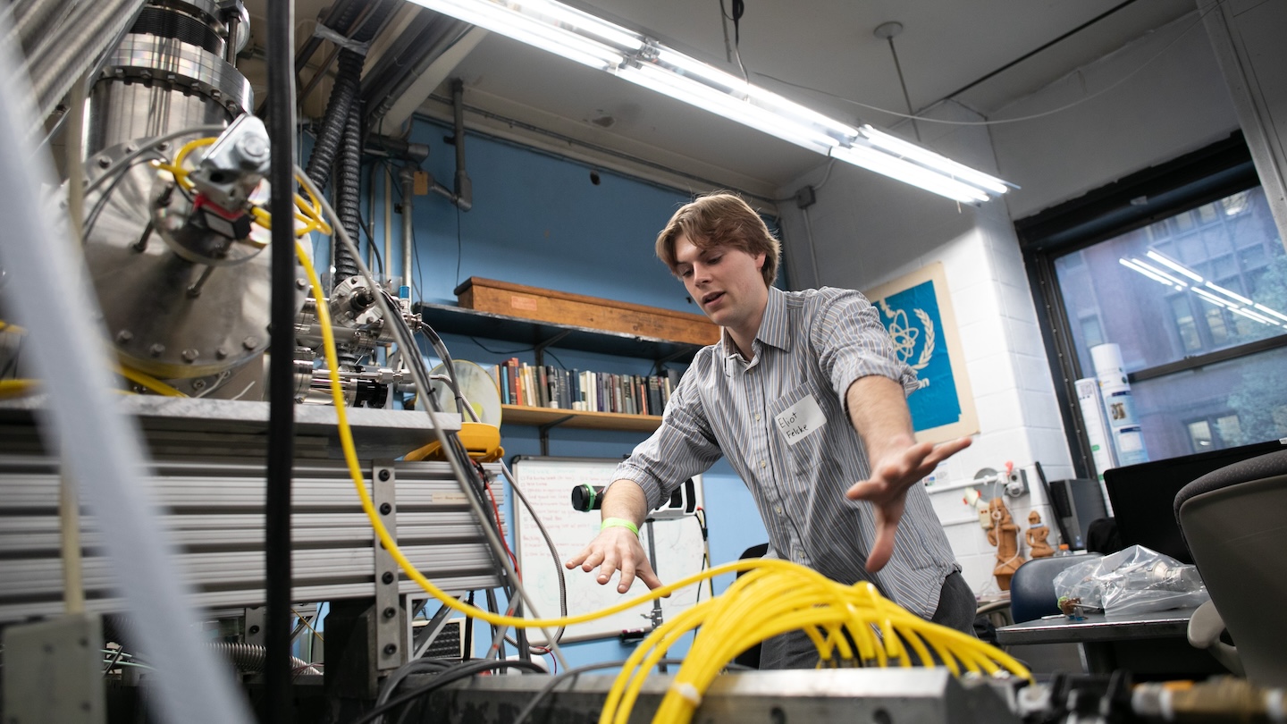 A person standing over a machine with several yellow cables strutting out