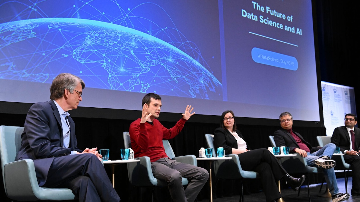 Five panelists sitting on stage in front of a screen that reads "The Future of Data Science and AI"