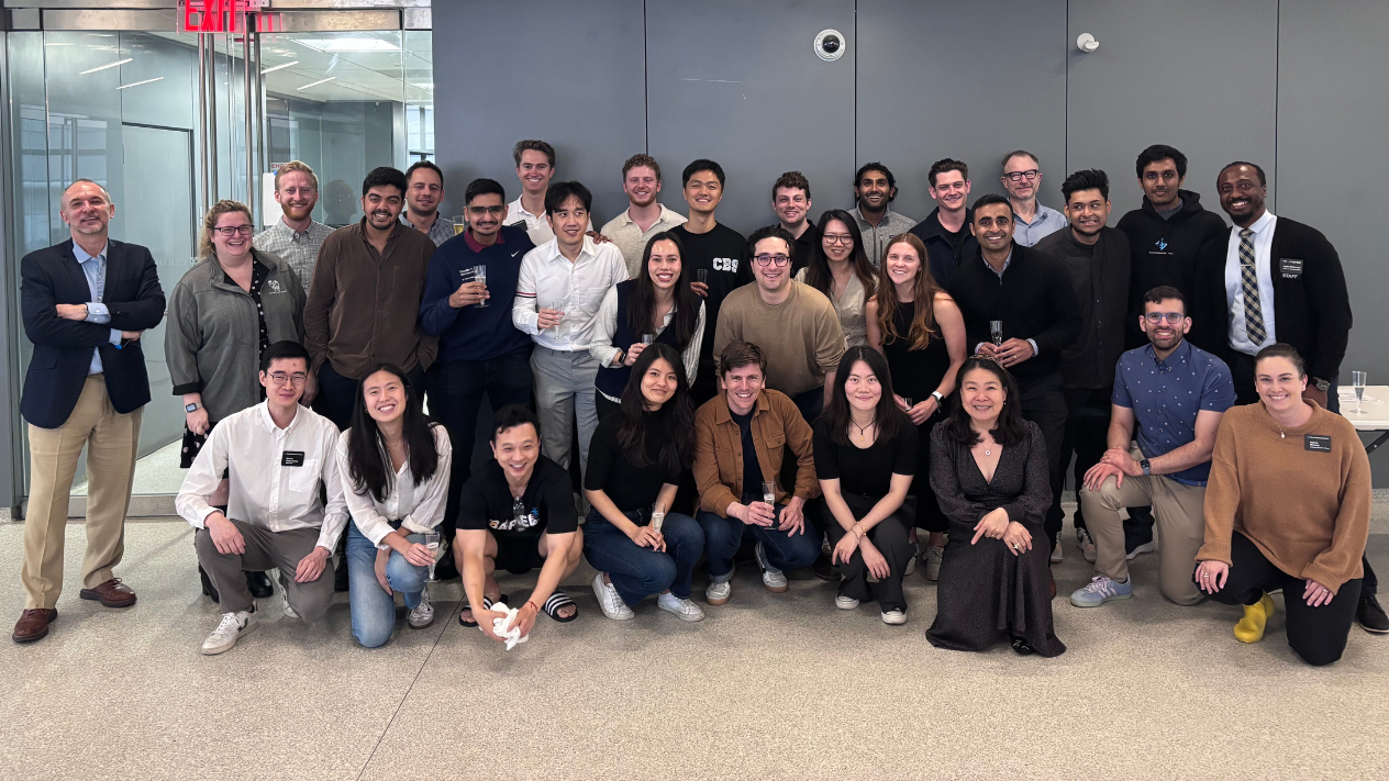 31 people posing for a photo in three rows