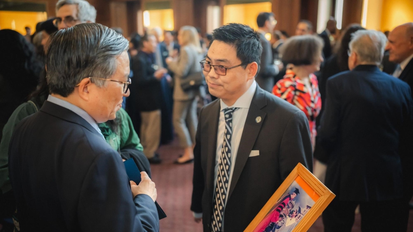 An alum shares his Class Day photo with Dean Chang at the CEAA Awards Dinner reception.
