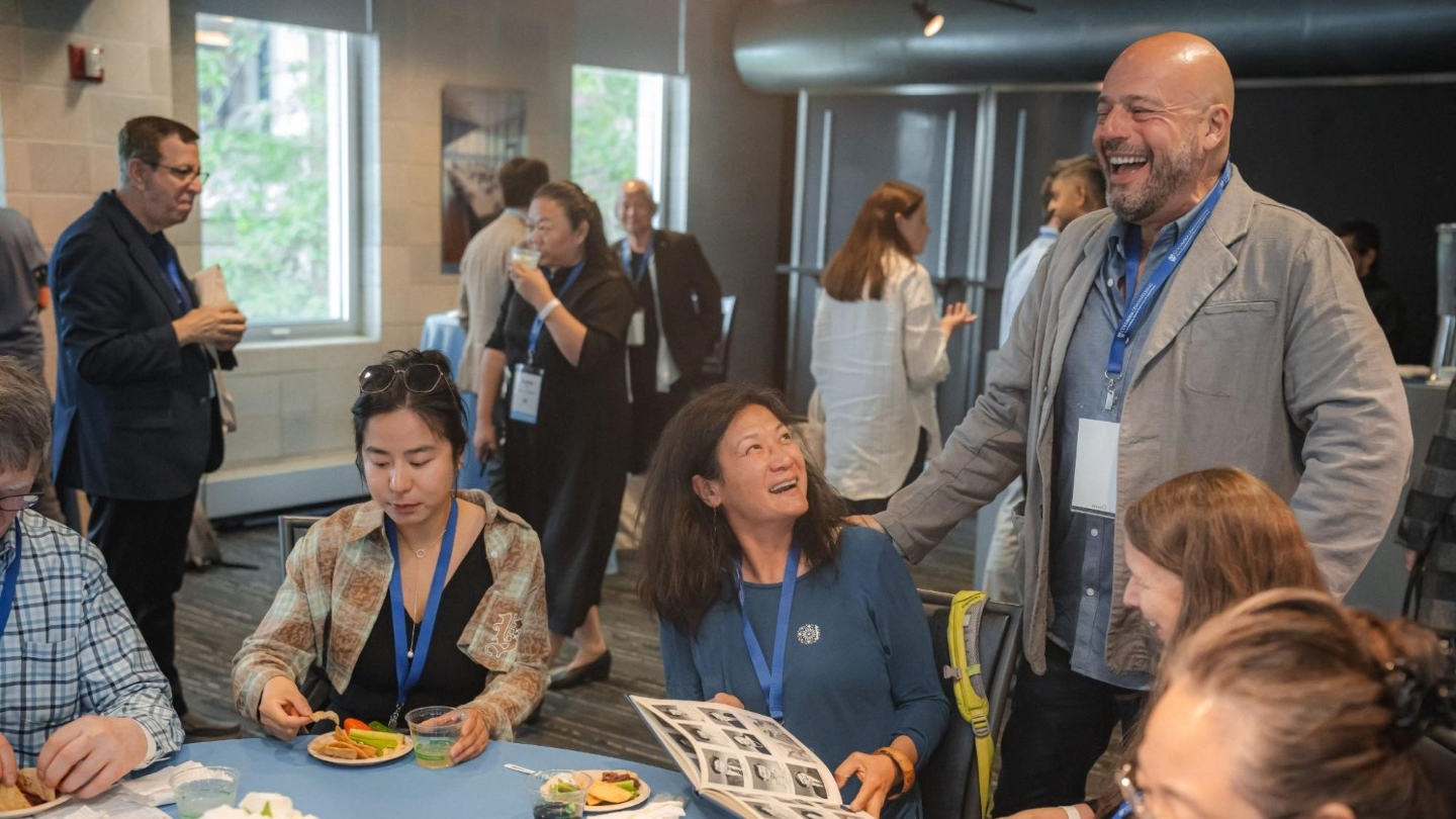 Columbia Engineering alums eating finger food and conversing around a table