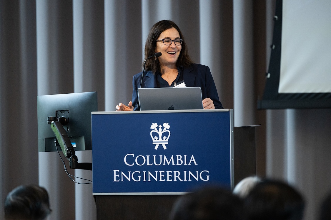 Shafi Goldwasser standing at a podium with a Columbia Engineering banner