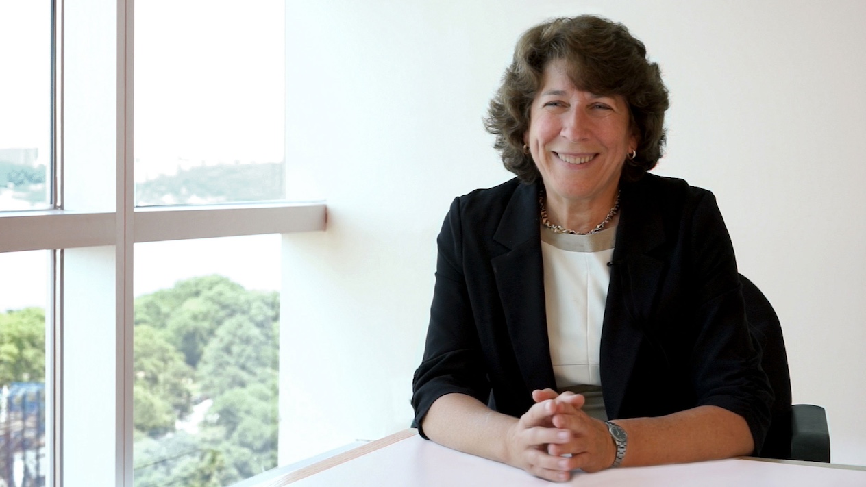 picture of Kathleen McKeown sitting at a desk next to a paneled window