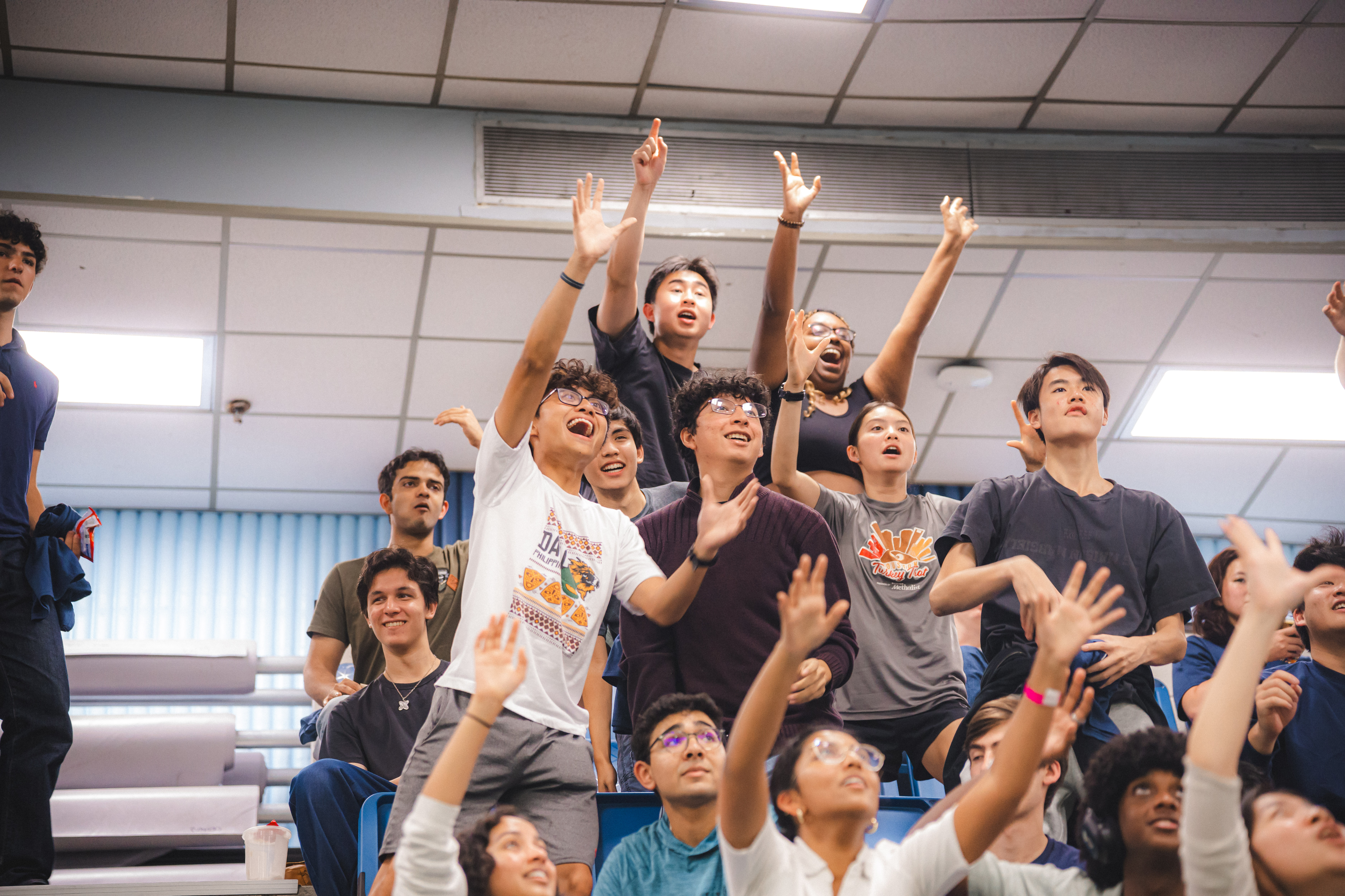 image of audience cheering and standing in the bleachers