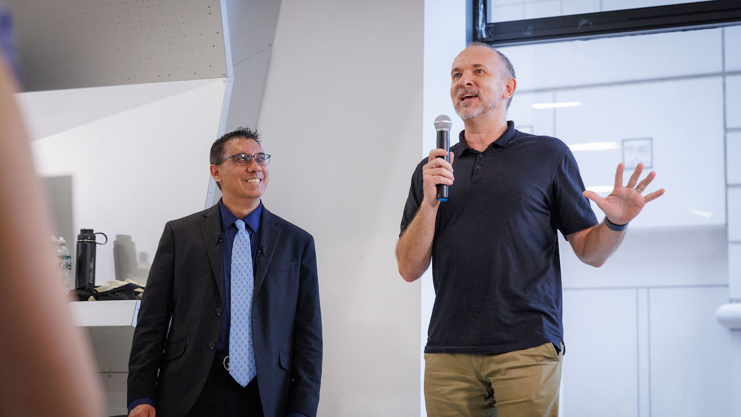 two speakers addressing an audience