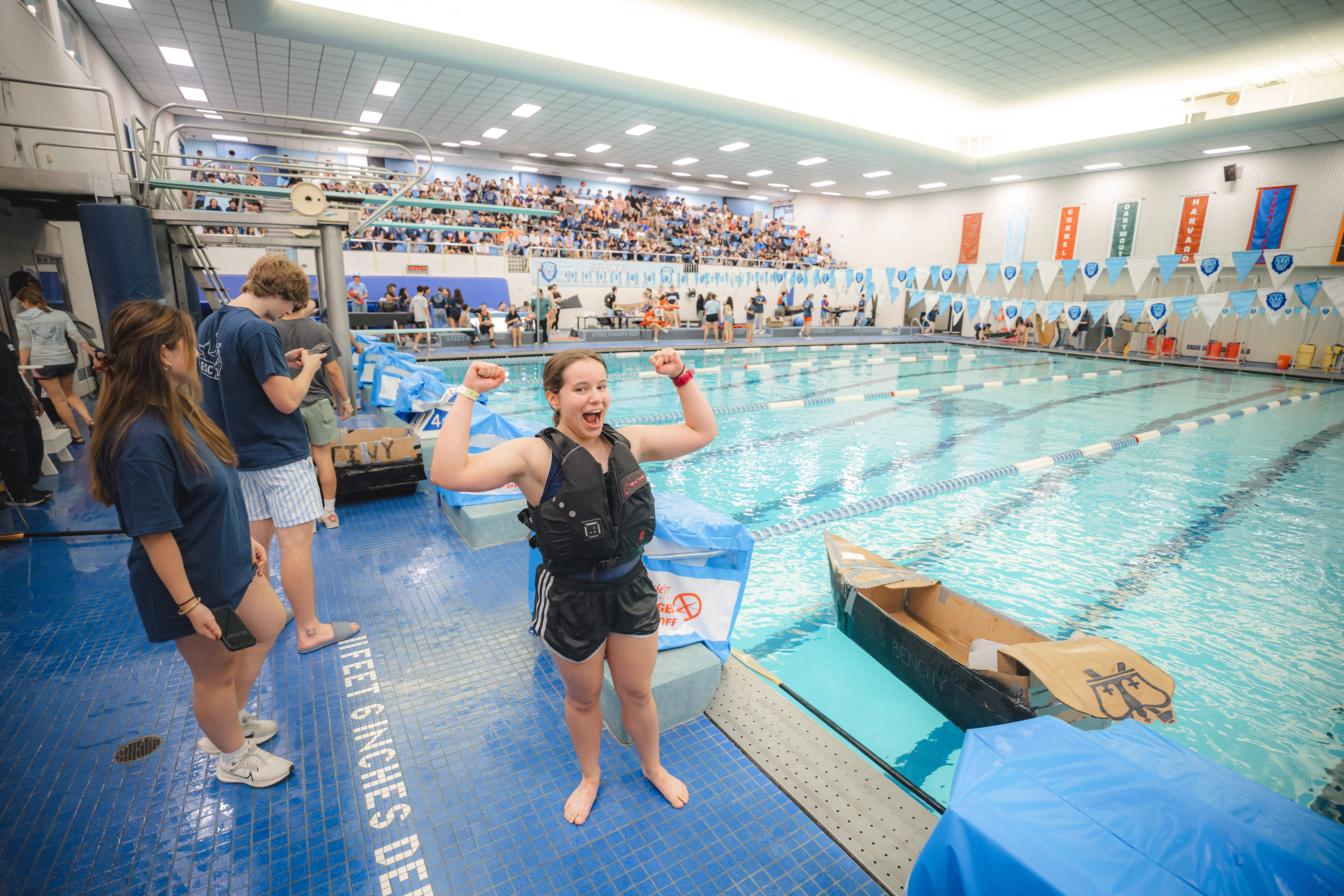 student posing next to the pool