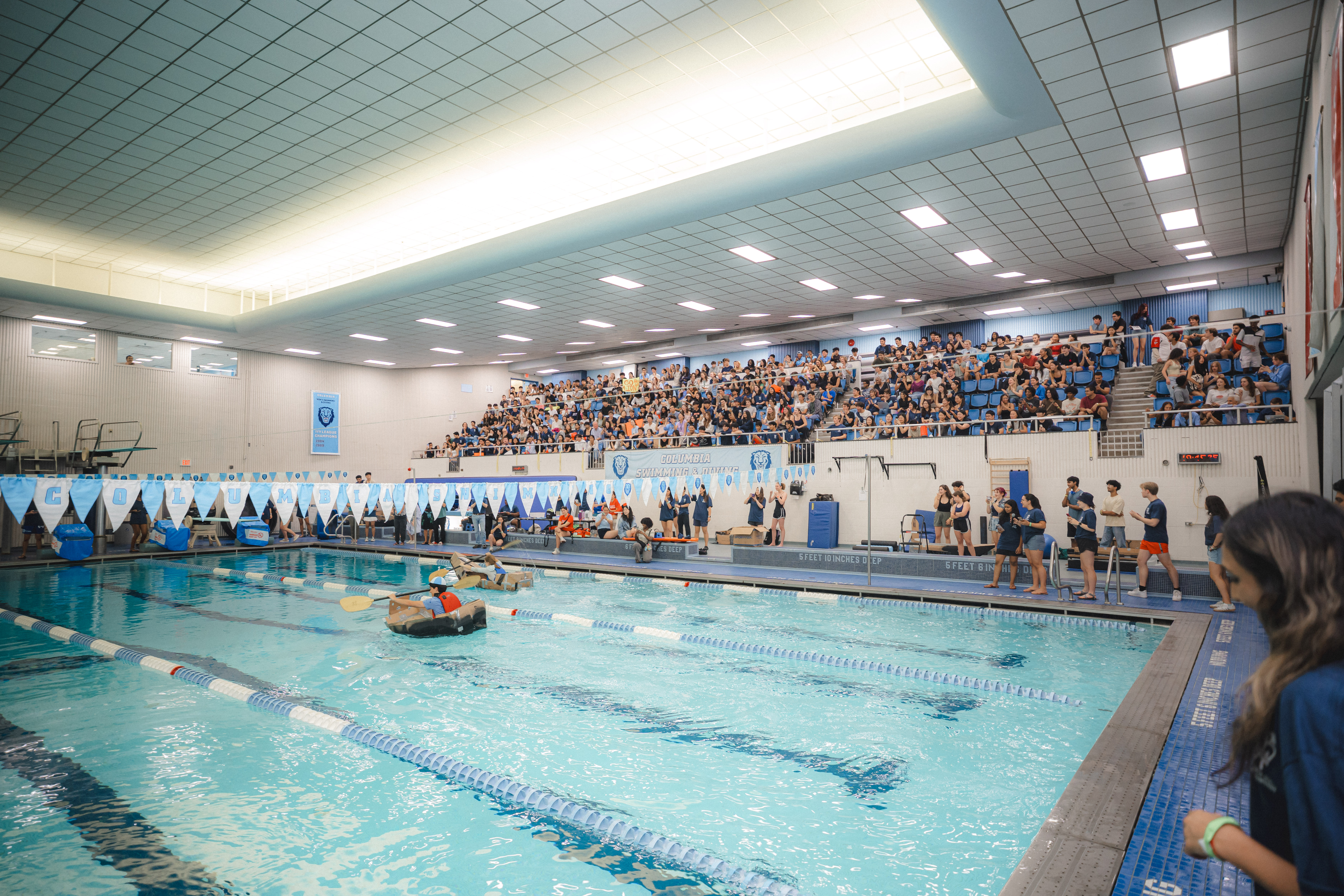 image of the pool with cardboard boats racing
