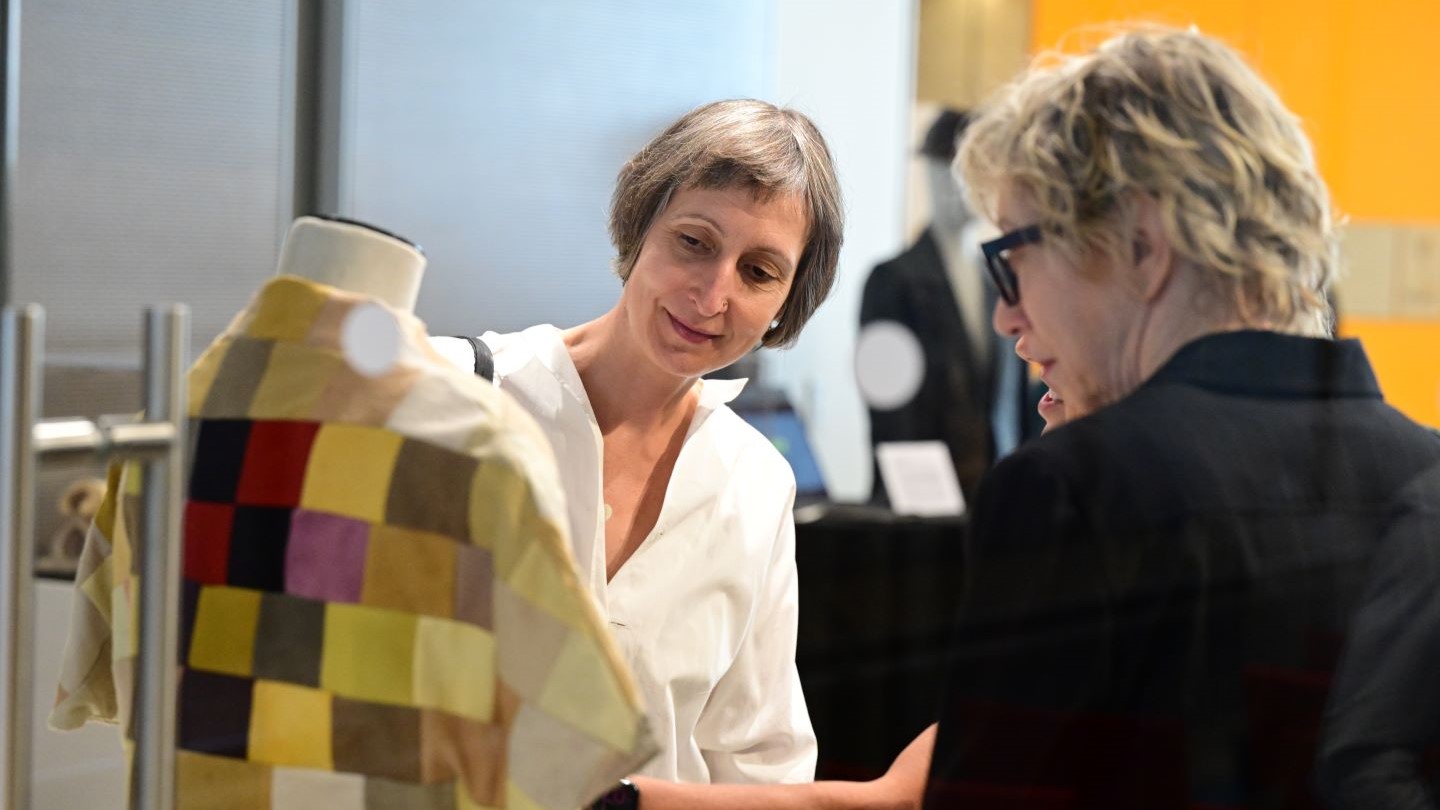2 people looking at biomaterials exhibition piece