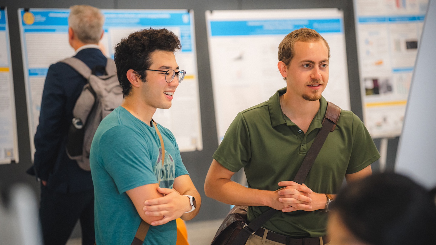 two climate week participants looking at poster of presentation