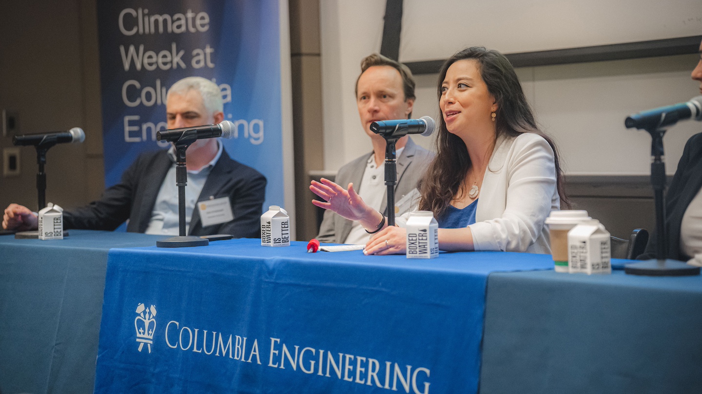 image of panelists speaking into microphones