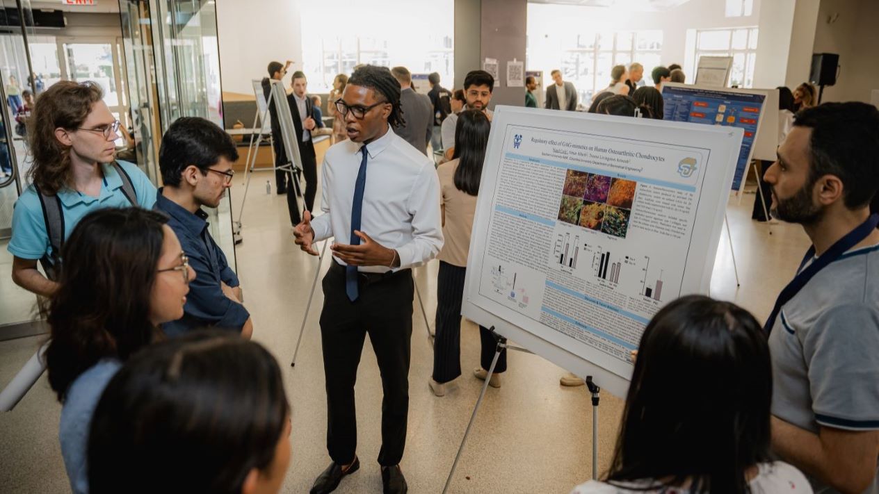 participants standing around research poster and researcher
