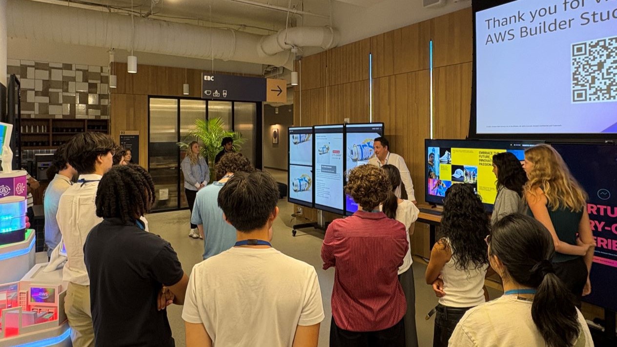 people gathered around large screen displaying information