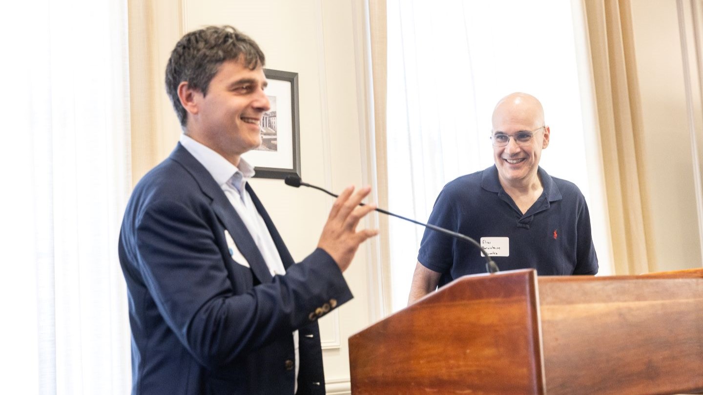 2 panelists speaking at a podium