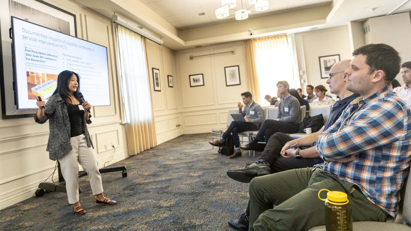 speaker giving presentation to an audience in a classroom setting