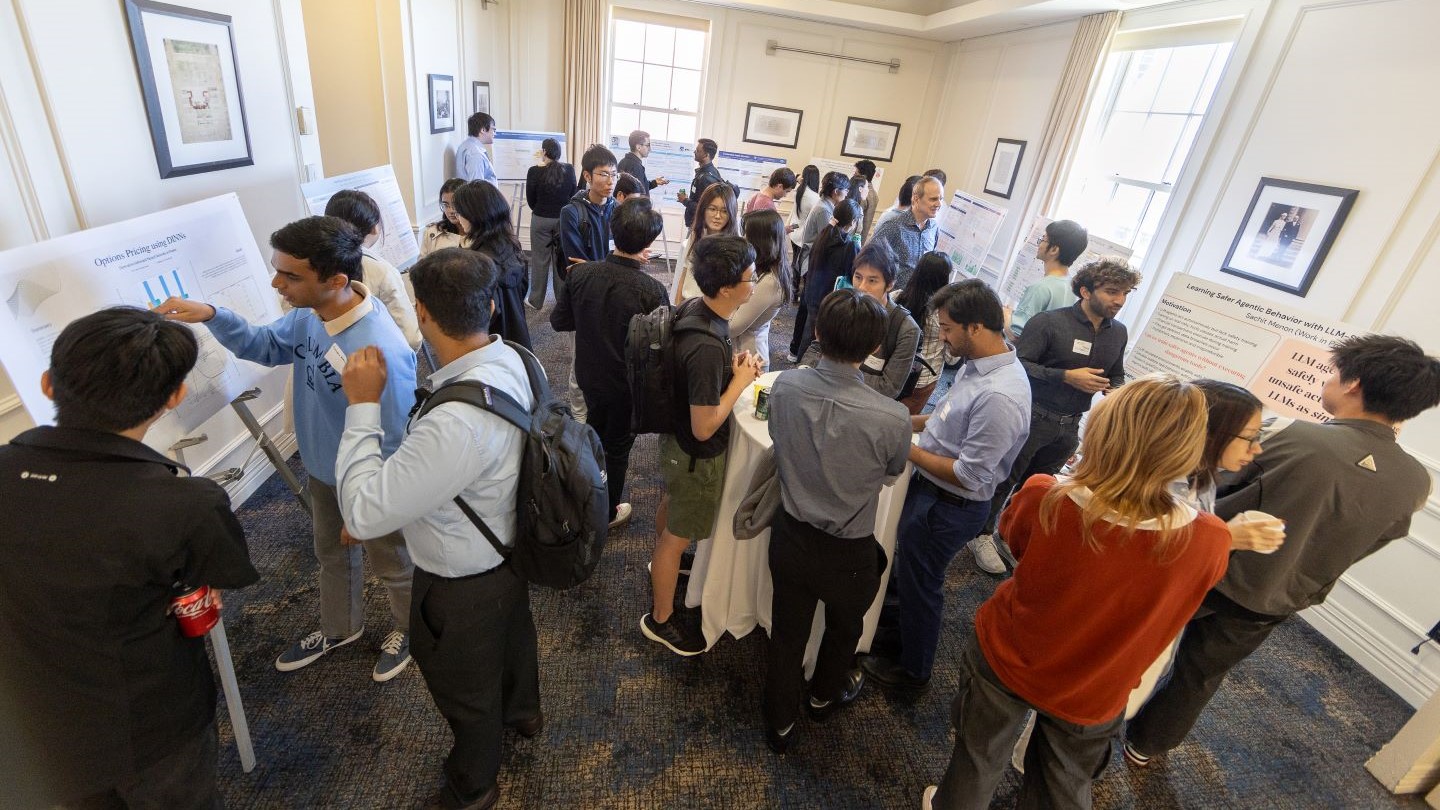 large group of audience and participants looking at research information