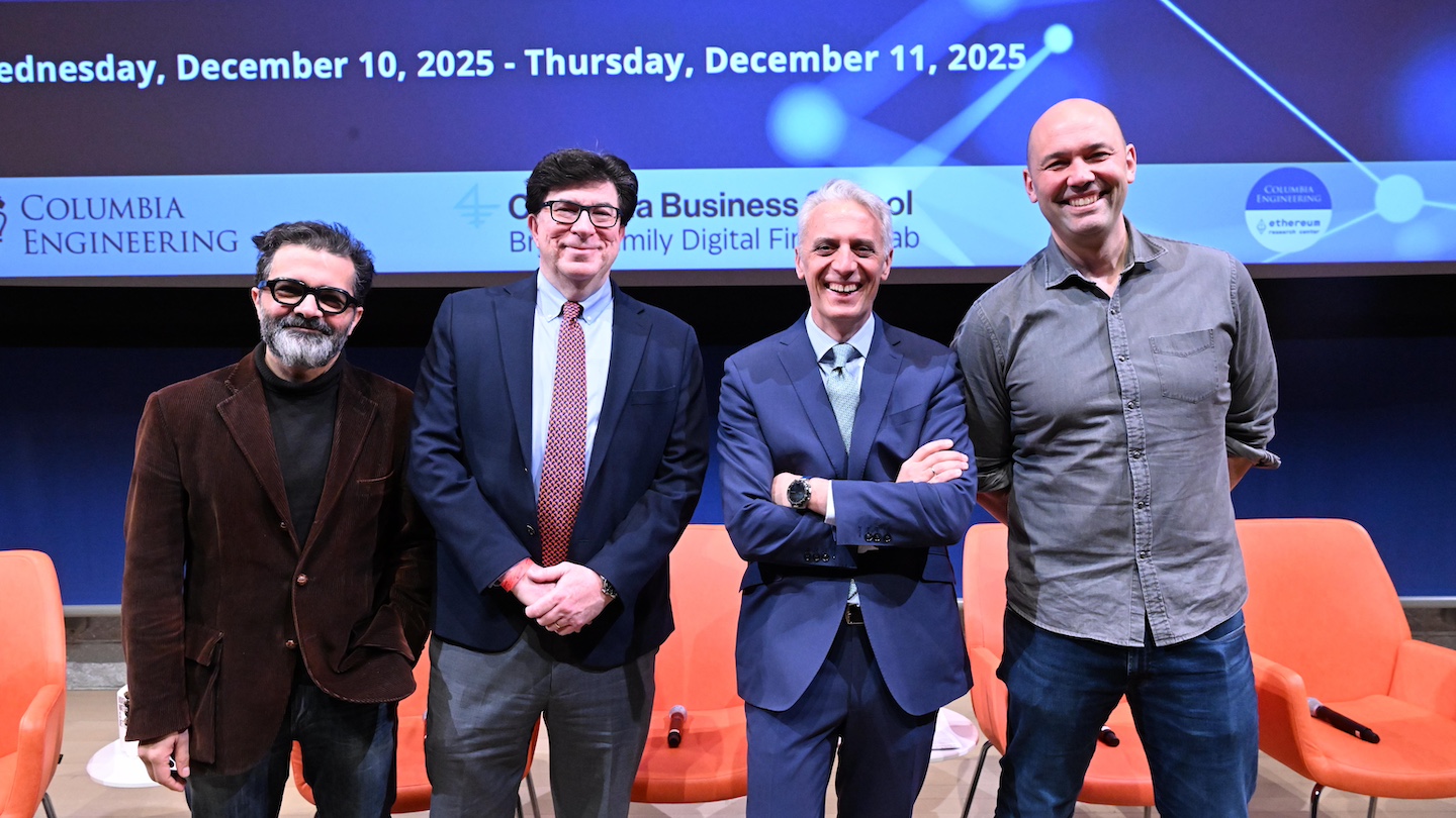 4 speakers posed for a picture on stage