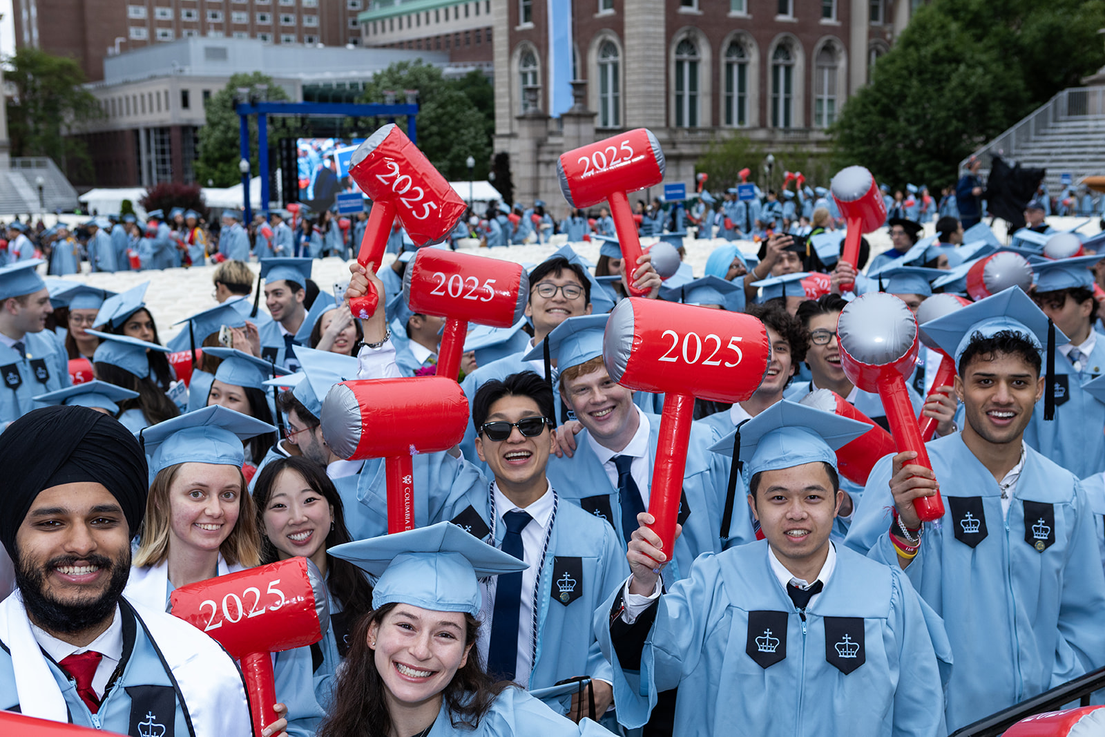 SEAS 2025 undergraduate graduates pose for a photo with hammers