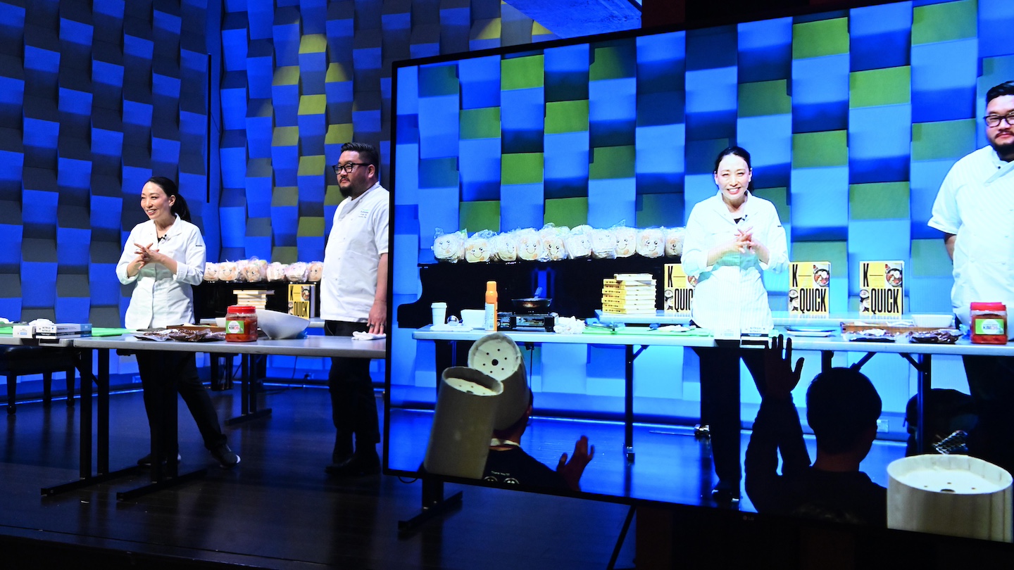 Judy Joo and 3 participants on stage for a kimbap making session
