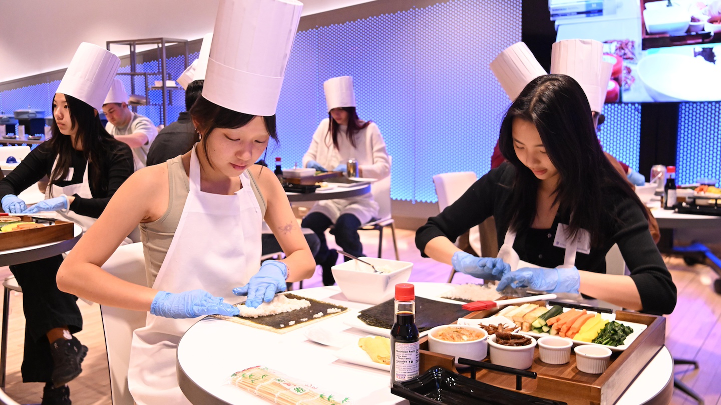 participants sitting together at a table making kimbap