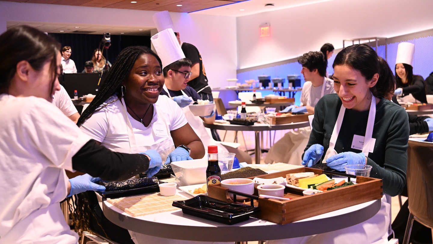 group of 3 participants making kimbap together