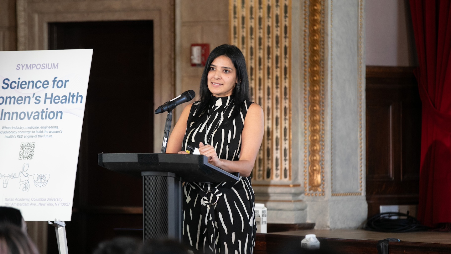 Women's health symposium speaker at podium