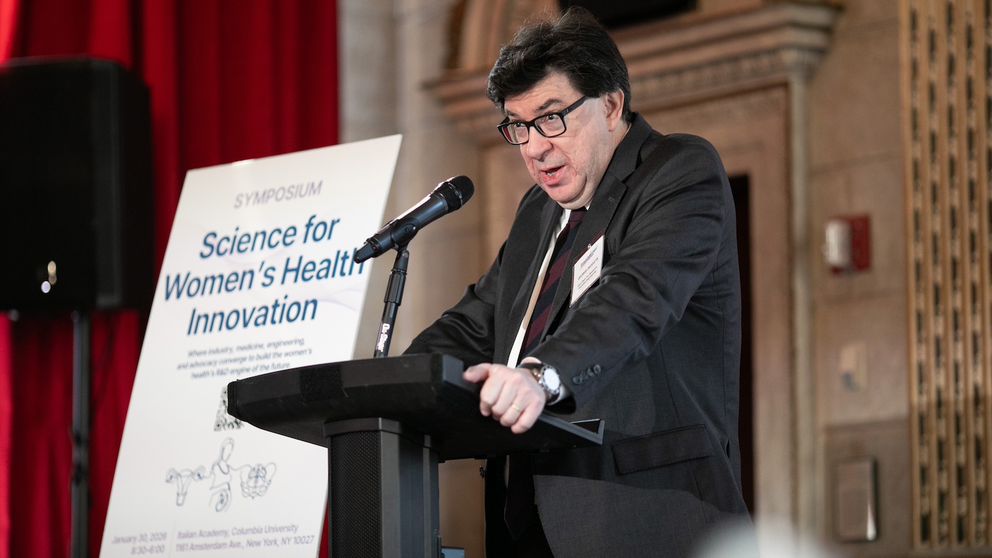 Women's health symposium speaker at podium