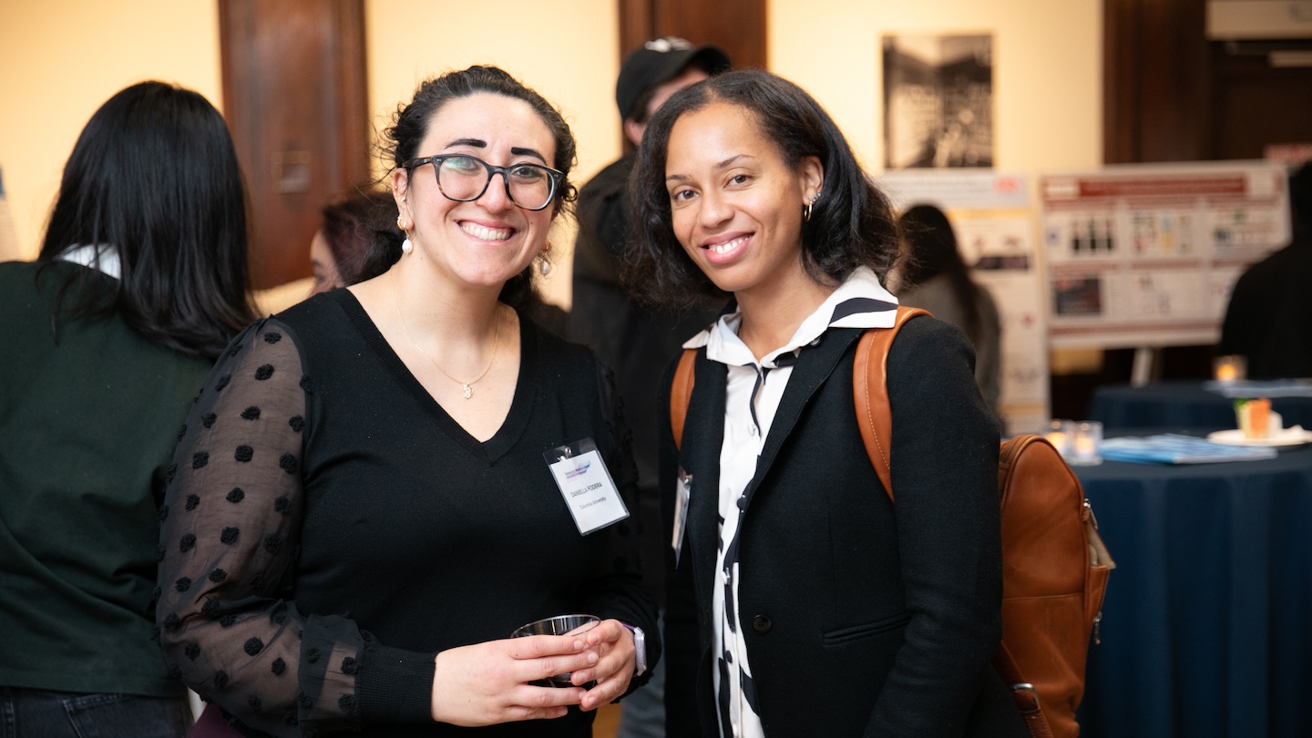 2 participants of the women's health symposium smiling for a photo