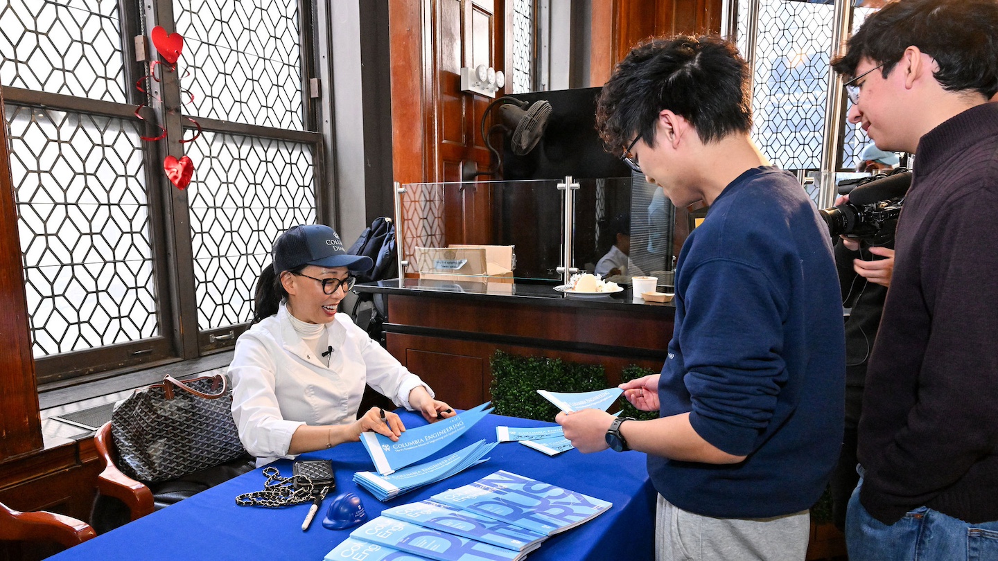 Judy Joo signing pennants for fans
