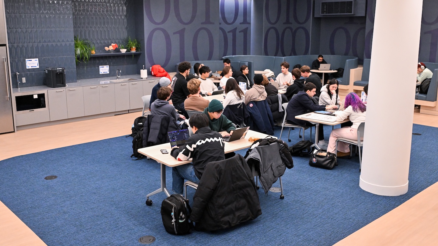 image of CS learning center lounge with students studying at tables